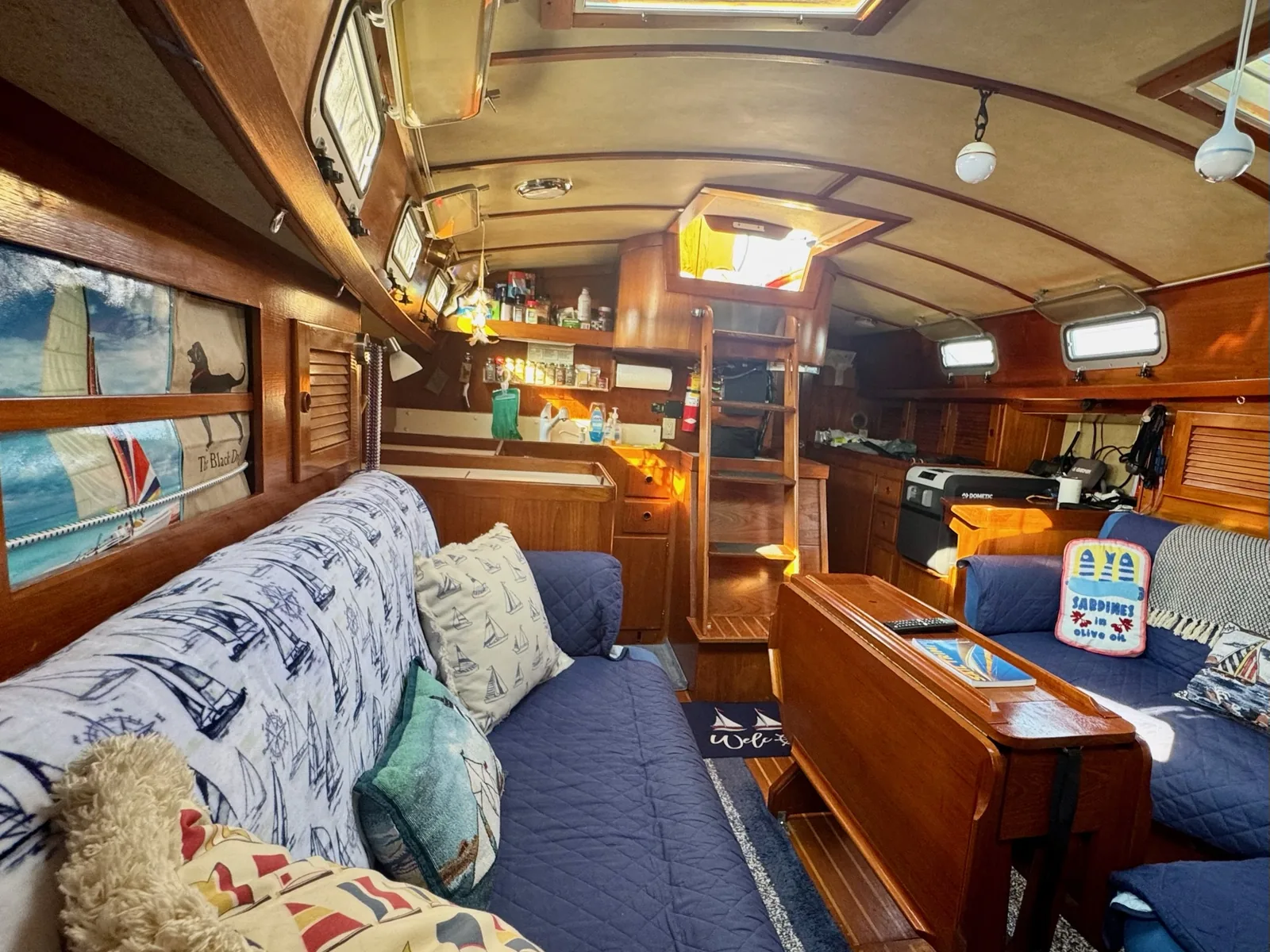 Teak saloon and galley below deck aboard Our Passion