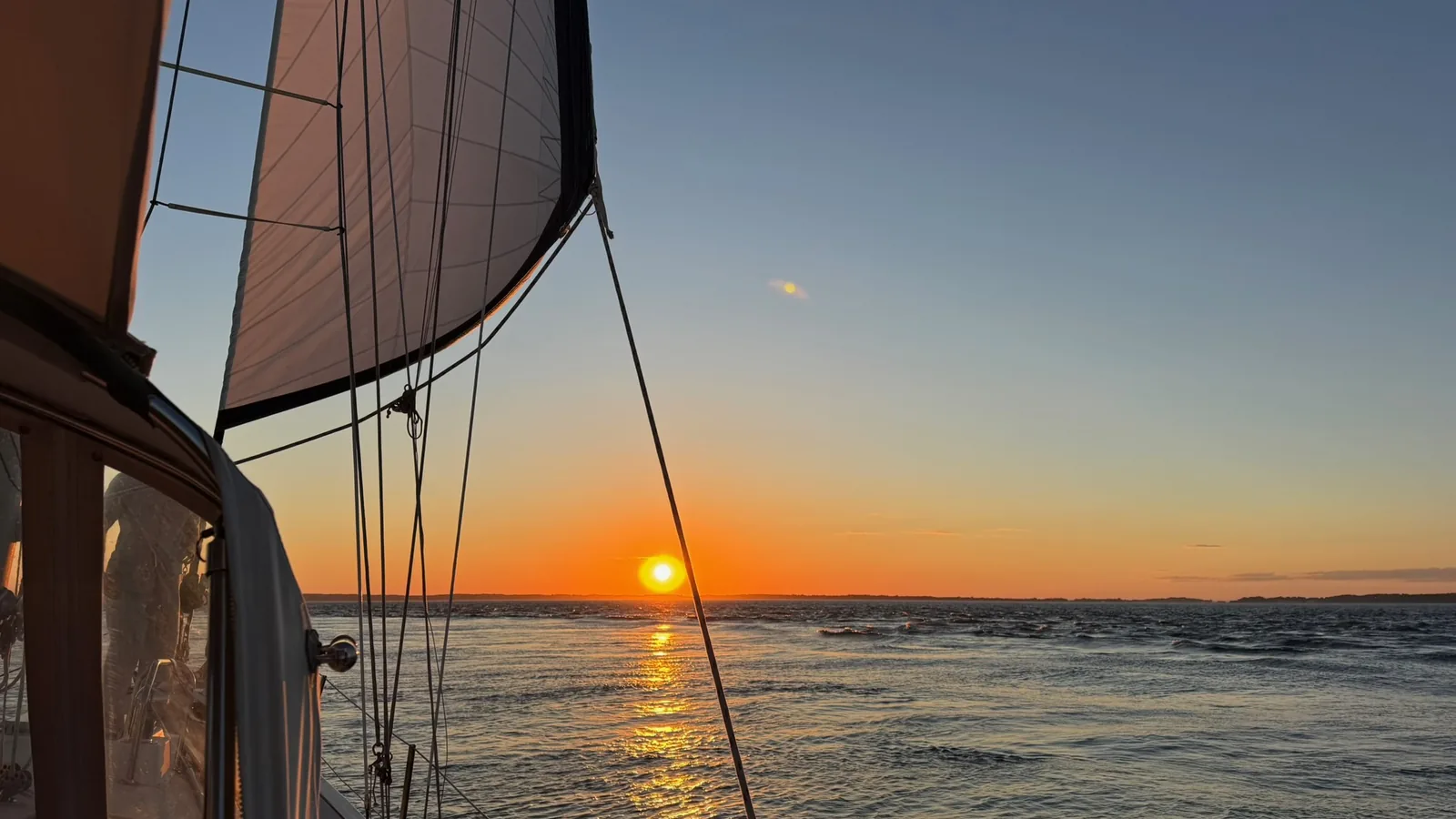 Sunset over Buzzards Bay from under sail